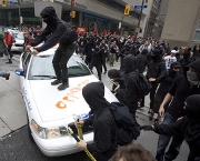Activists attack a police car in Toronto's financial district during the G20 Summit Saturday, June 26, 2010. THE CANADIAN PRESS/Darren Calabrese