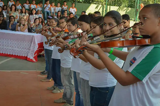 crianças tocando violino em escola